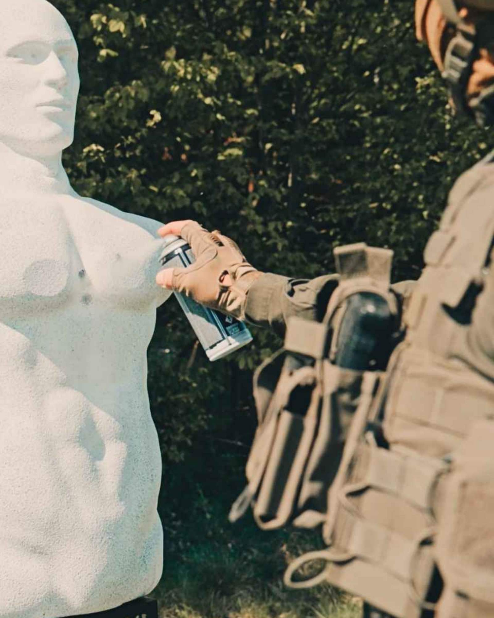 Spray and reset workflow on a white EkoLebo rubber target after live-fire use